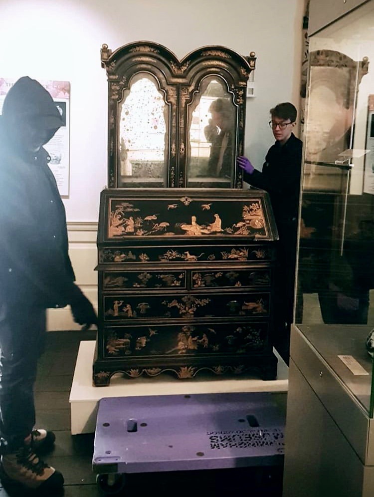 Christopher and the technician Gary stabilising a japanned bureau in the Blue Room at Aston Hall